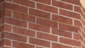 African descent teenage boy moves into the college dorm after high school.  He is excited about his next new adventure.  His family says goodbye outside the campus dorm.  Vehicle filled with his belongings is in background.